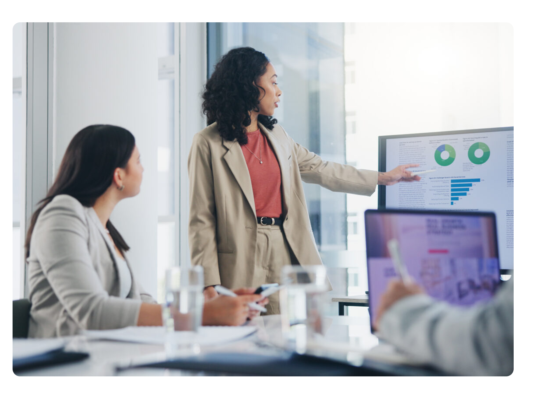 woman pointing at digital screen at analytics