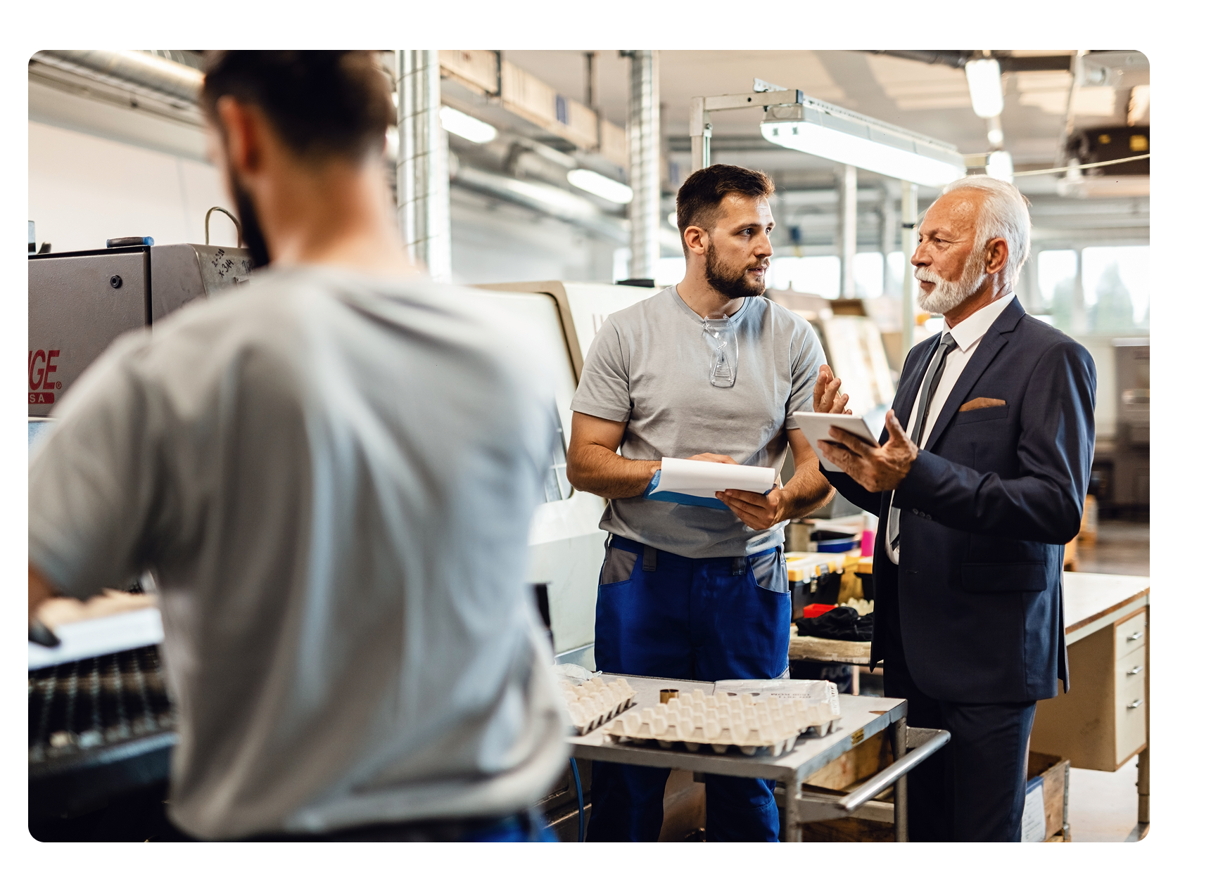 VP of operations talking to a manufacturing shop floor employee
