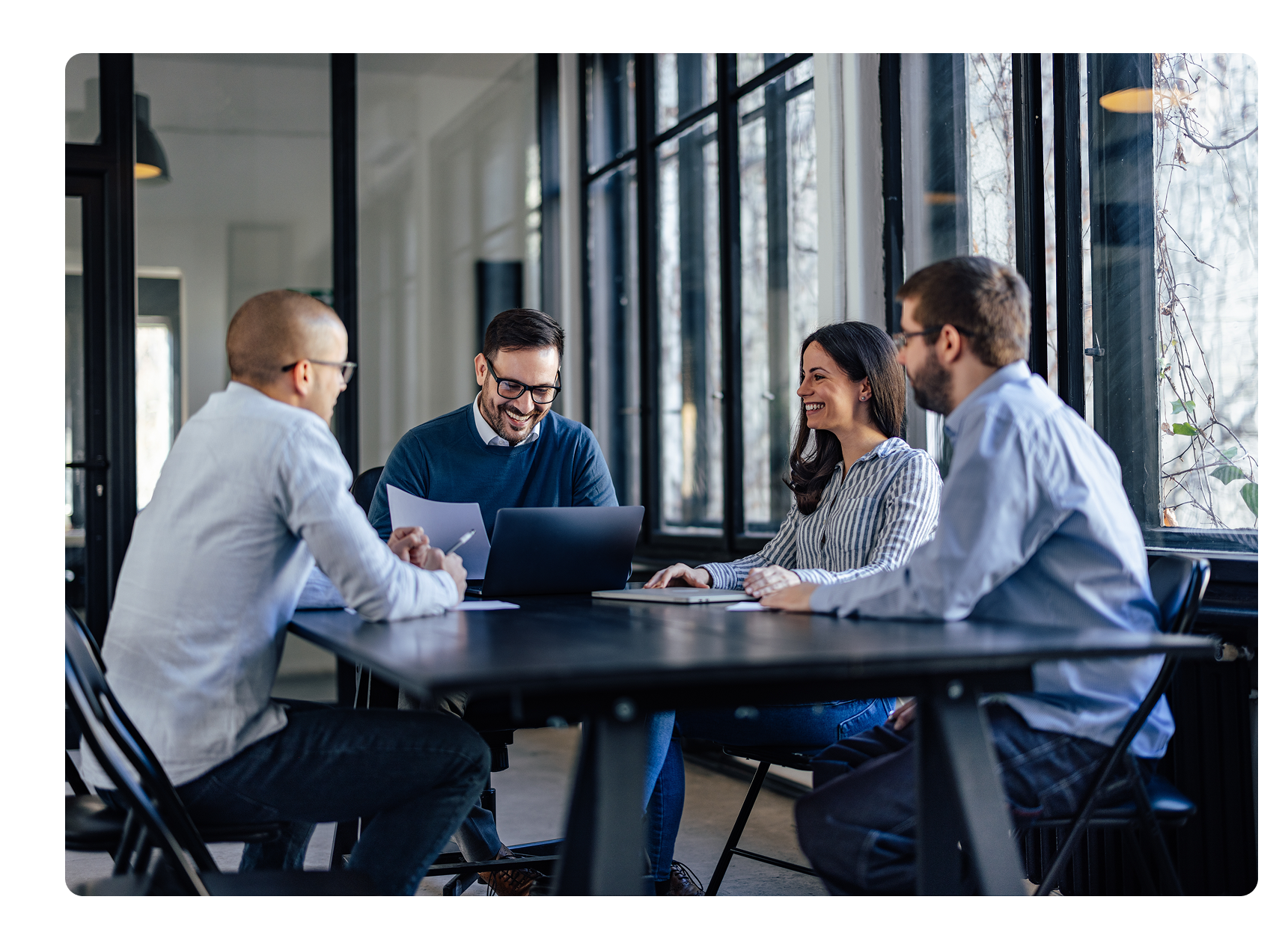 four business partners meeting in a conference room